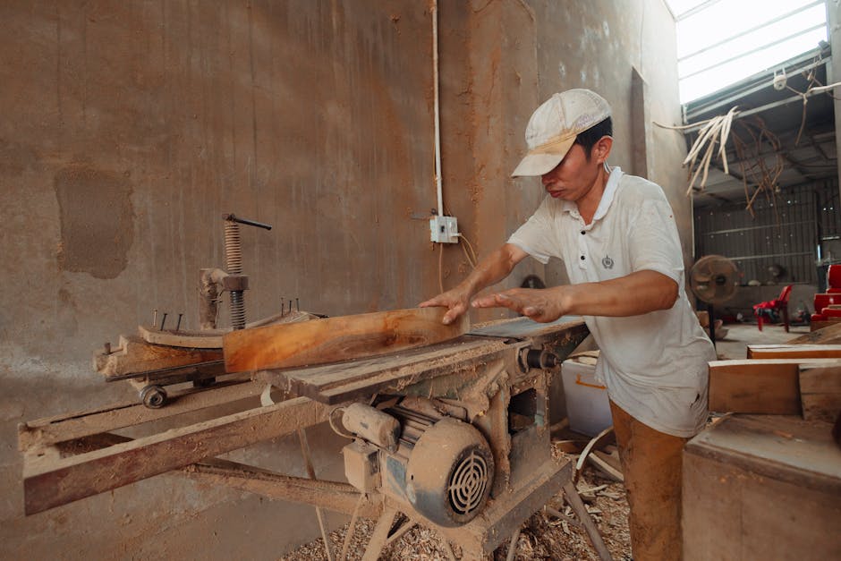 Carpenter working meticulously in a woodworking workshop